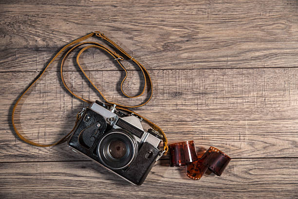 istock Old retro camera on vintage wooden boards abstract background 472476572