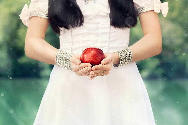 Snow-White Princess with Famous Red Apple Snow White holding the red poisoned apple in fantasy scene snow white and the seven dwarfs photos stock pictures, royalty-free photos & images
