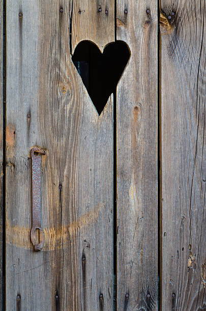 istock wooden restroom door with heart shape 472478466