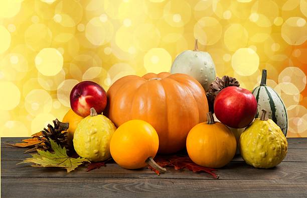 istock Assorted pumpkins and squashes on rustic wooden boards with an 472479390