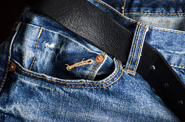 istock Detail of nice blue jeans with leather belt 472483080