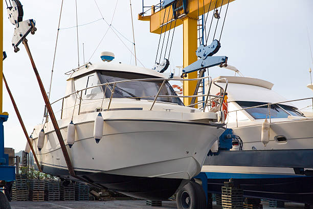 istock Boat wheel crane elevating motorboat to yearly paint 472484886