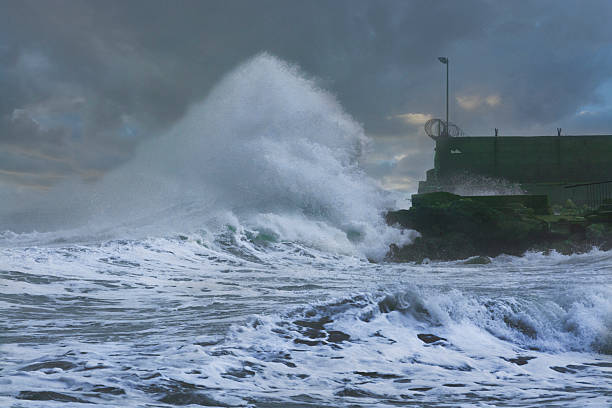 istock Sea storm waves crashing and splashing against pier 472485014