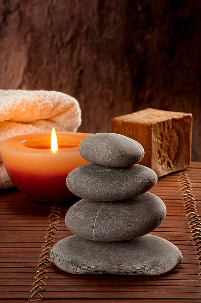 istock SPA atmosphere with four stones with candle light and soap 472485888