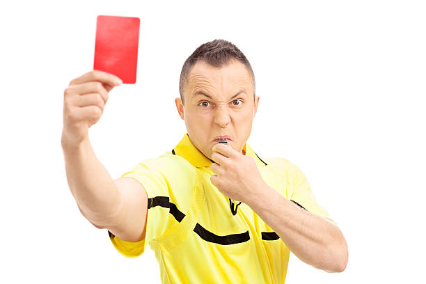 Furious football referee showing a red card Furious football referee showing a red card and blowing a whistle isolated on white background judge sports official stock pictures, royalty-free photos & images