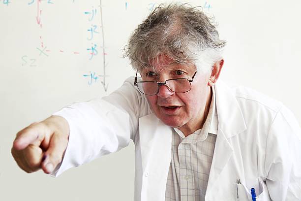 istock senior teacher with hand outstretched as if  pointing at class 472489750