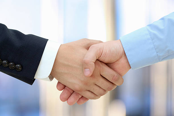 istock Image of a firm handshake  between two colleagues 472490000
