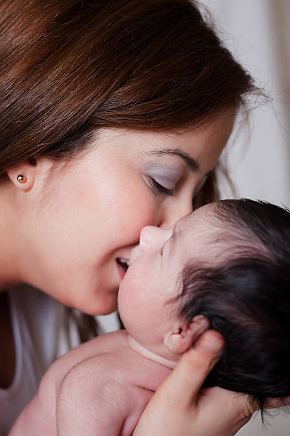 istock Mother Kissing Her Baby 472492056