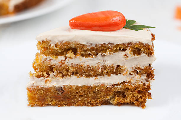 istock Slice of gourmet easter cake with cream and little orange 472493348