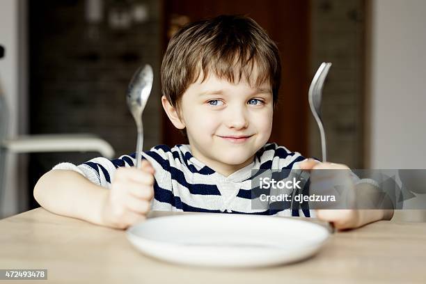 Happy Little Boy Waiting For Dinner Stock Photo - Download Image Now - Child, Eating, Hungry