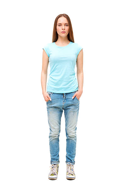 istock Young woman standing with hands in jeans pockets 472493856