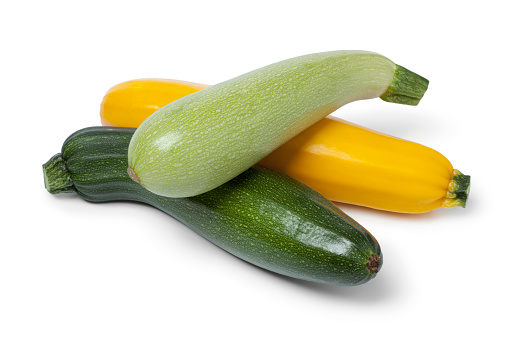 Fresh raw courgettes in different colors on white background