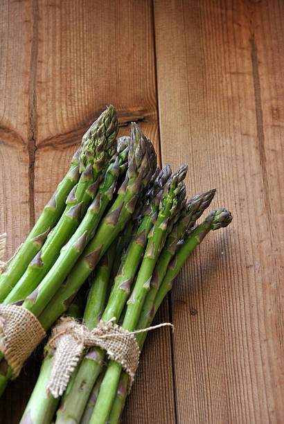 istock organic asparagus on wooden table 472499912