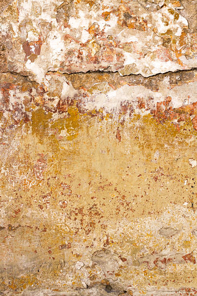 istock Yellow-Orange Cracked Mottled Roman Wall Background Texture 472500000