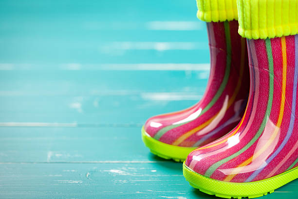 istock Baby rubber boots on turquoise table 472500062