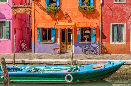 Burano island canal, colorful houses and boats, Italy, Europe