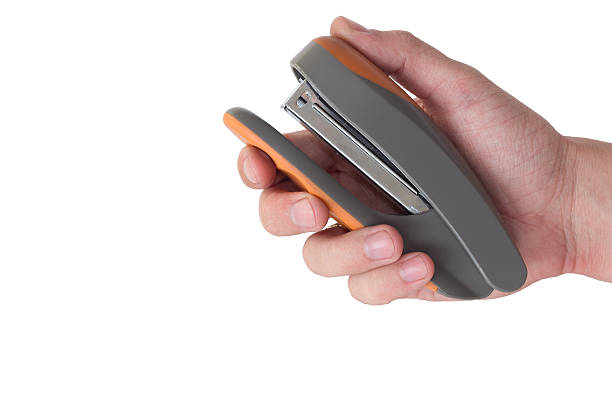 istock office stapler in hand isolated on white background 472504610