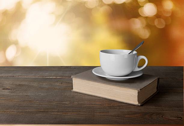 istock Tea. Cup of coffee and book on wooden table 472506808
