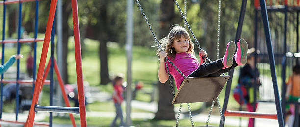 Little Girl on a Swing in park