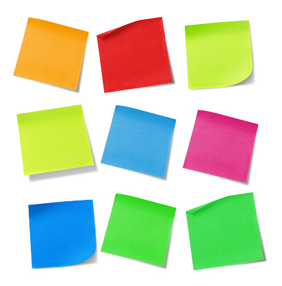 Multicolored adhesive notes on white background