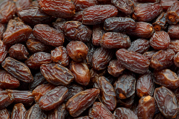 istock Fresh dried date fruits background 472507982