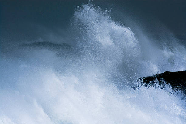 istock Sea storm waves dramatically crashing and splashing against rocks 472509626