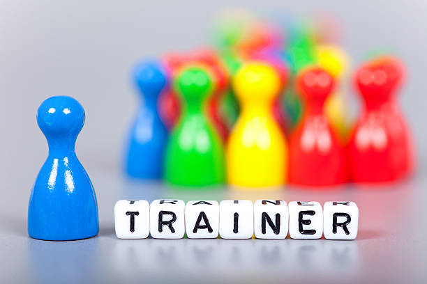 istock Cube Letters show trainer  in front of unsharp ludo figures 472509664
