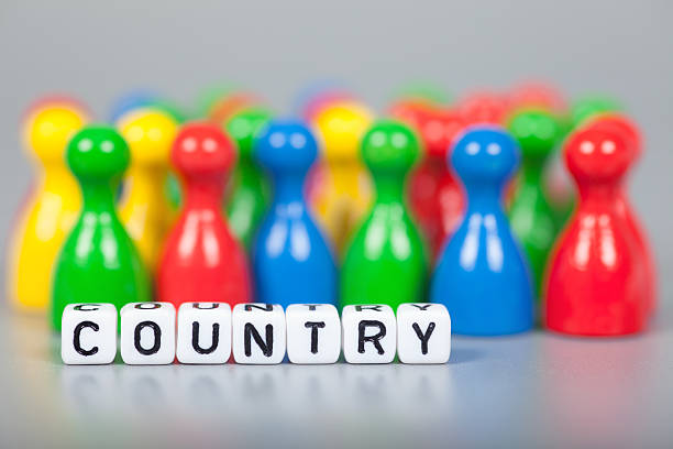 istock Cube Letters show country  in front of unsharp ludo figures 472509668