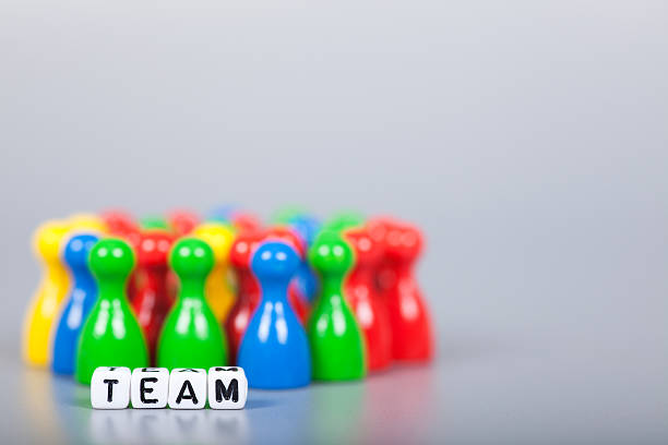 Cube Letters show team  in front of unsharp ludo figures. Background is light gray
