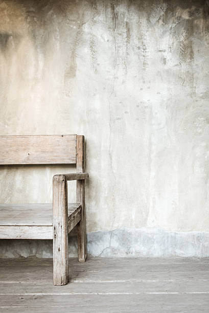 istock Old chair in front of concrete wall with copy space 472511562