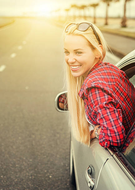 istock Happy young woman looking out from car window 472511618