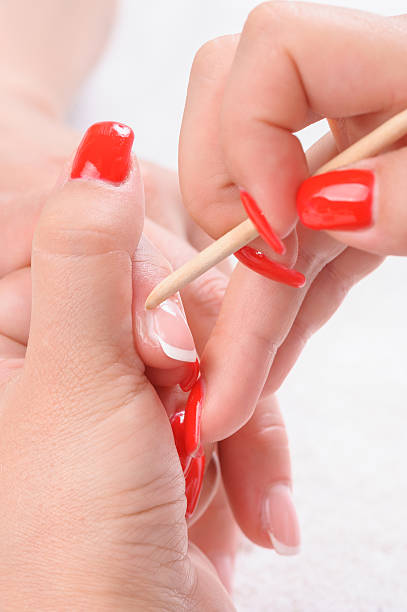istock manicure applying - cleaning the cuticles 472511678