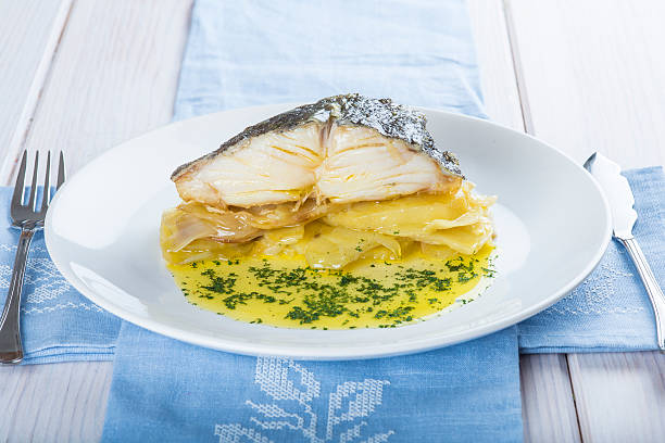 Oven baked cod fish with potatoes stock photo
