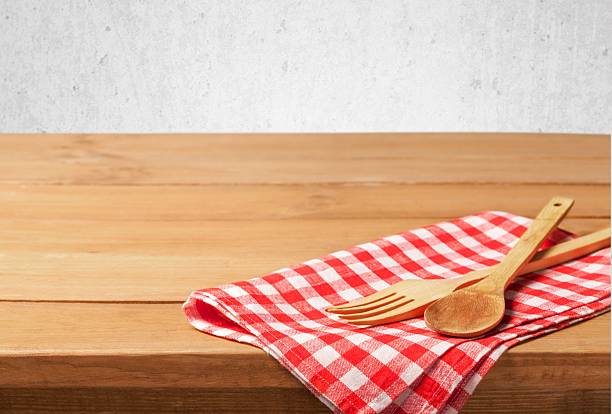 istock Kitchen utensils on tablecloth on wooden table over grunge background 472518156