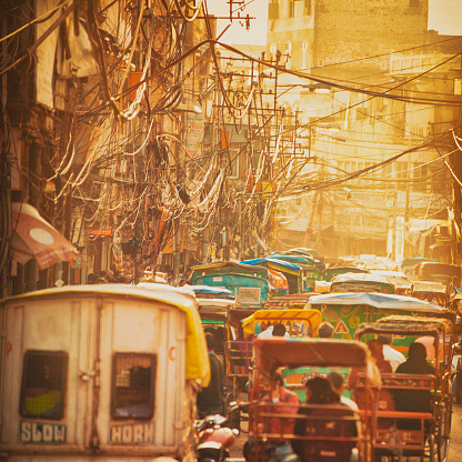 Busy street at sunset in Old Delhi, India.