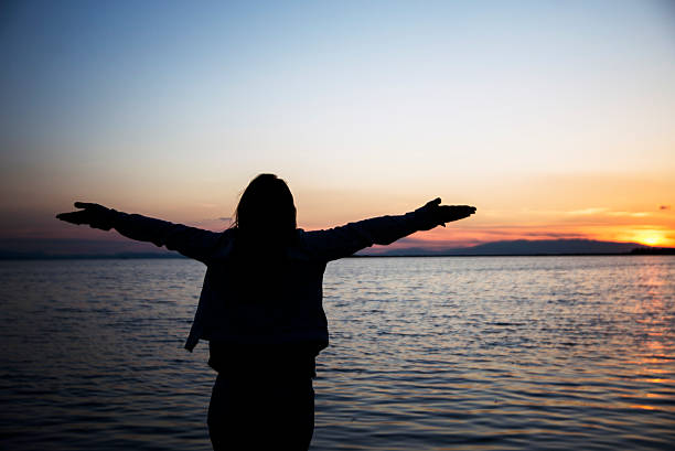 istock Woman open arms in the dusk. 472522186