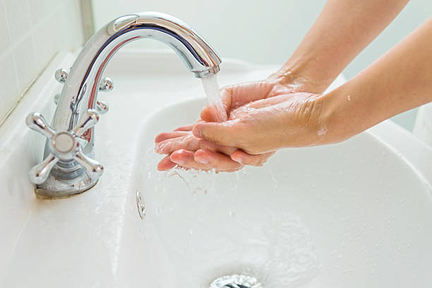 istock A person washing their hands in the sink 472522978