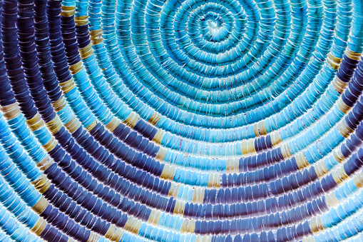 This is a close up photo of a circular indian basket that I inverted and then adjusted to give a unique blue hue.