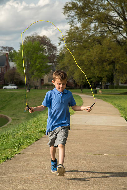 istock Boy jumping rope in the park 472527442