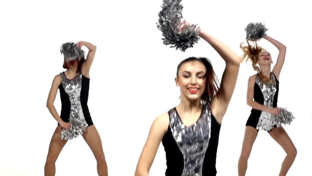 Girl in black costume  with pom-poms dancing on  white background. Close up, slow motion