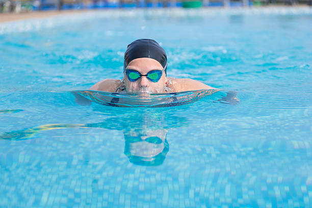 istock Young girl swimming butterfly stroke style 472537868