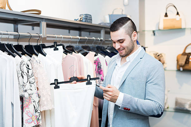 istock man choosing new female garment 472538918