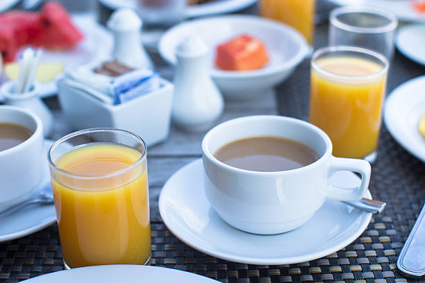 istock Delicious tasty cappuccino and fresh juice for breakfast 472540826