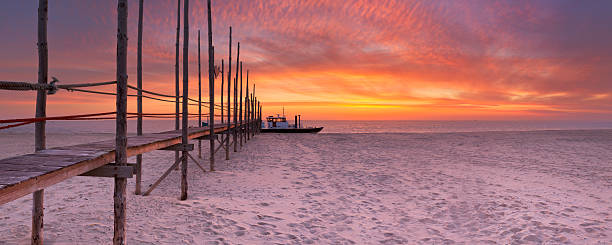 istock Seaside jetty at sunrise on Texel island, The Netherlands 472542116
