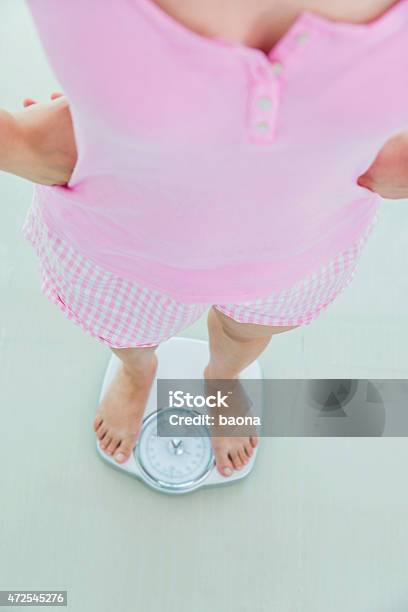 Standing On A Scale Stock Photo - Download Image Now - 2015, Adult, Adults Only