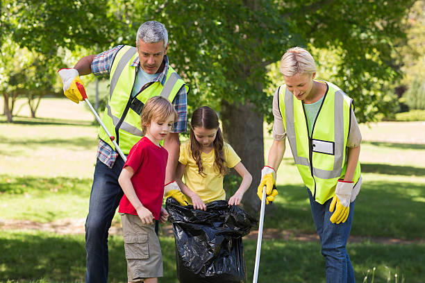 istock Happy family collecting rubbish 472548776