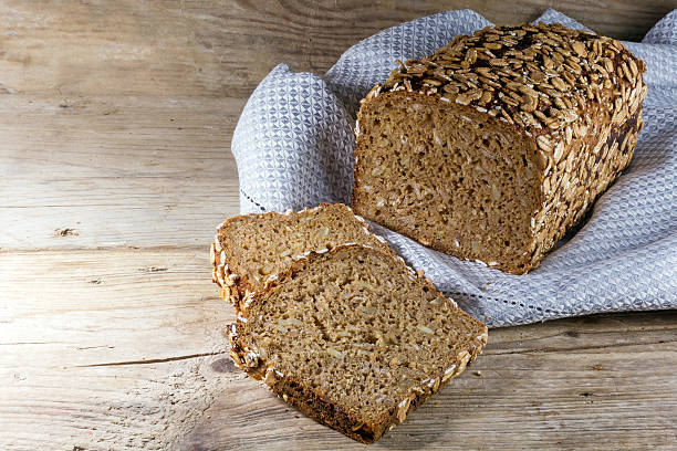 istock bread loaf and slices on rustic wood, copy space 472548940