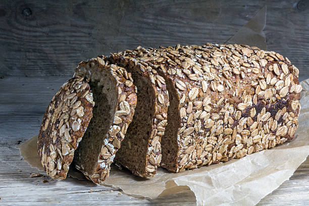 istock dark bread loaf with whole grain on old wood 472548944