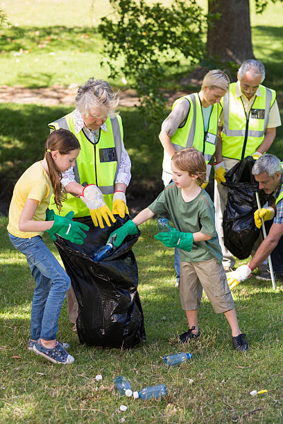 istock Happy family collecting rubbish 472551076