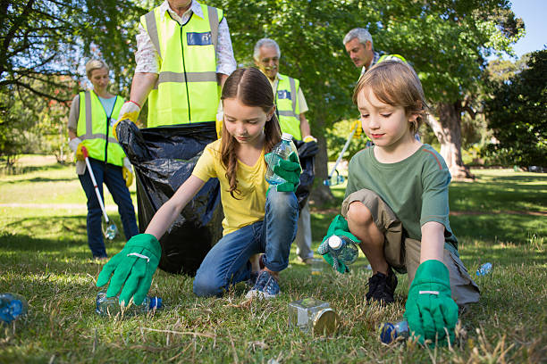 istock Happy family collecting rubbish 472551084